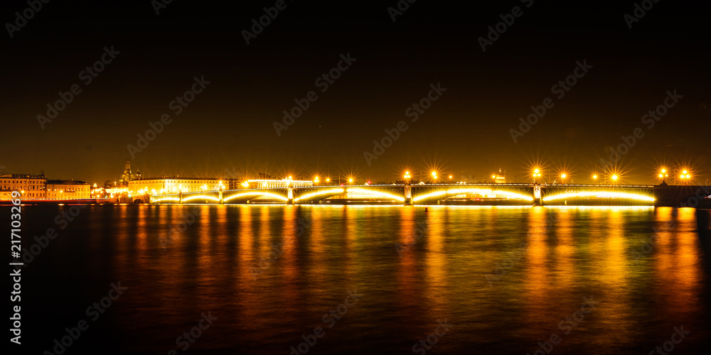 Photography of long-term exposure - night landscape. Night city river. Moon. Is defocused light dots bokeh background