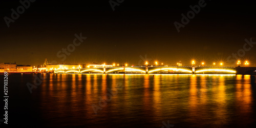 Photography of long-term exposure - night landscape. Night city river. Moon. Is defocused light dots bokeh background