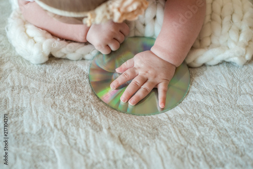 Little DJ, Little Baby, CD drive, takes a hand on the bed.