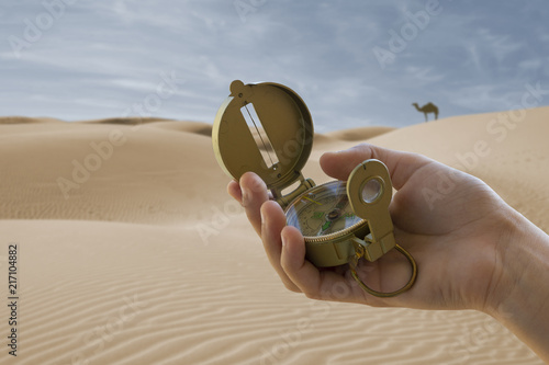 compass in hand and desert background