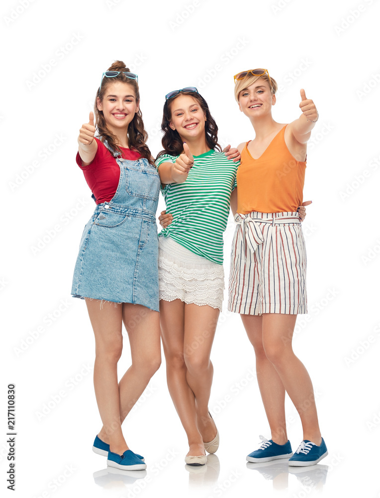 friendship and people concept - group of happy female smiling friends showing thumbs up over white background friendship and people concept - group of happy female smiling friends showing thumbs up over white background