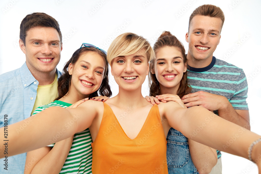 friendship and people concept - group of happy smiling friends taking selfie over white background friendship and people concept - group of happy smiling friends taking selfie over white background