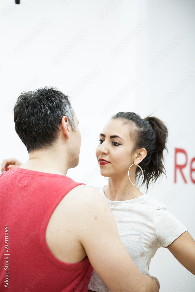 Beautiful young woman dancing kizomba. Man making great kizomba poses with her girl Beautiful young woman dancing kizomba. Man making great kizomba poses with her girl