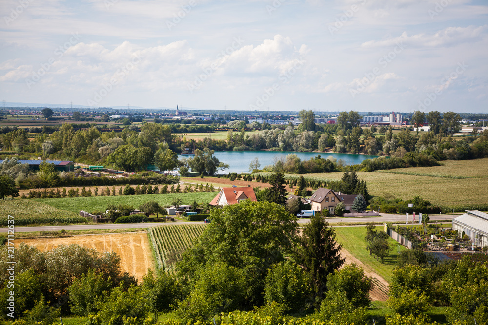 Aerial landscape view to lake surrounded with trees and little village in Germany