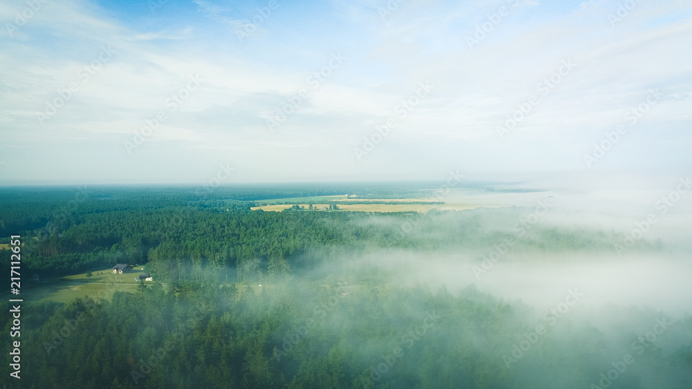 Misty sunrise over countryside path Aerial view Latvia