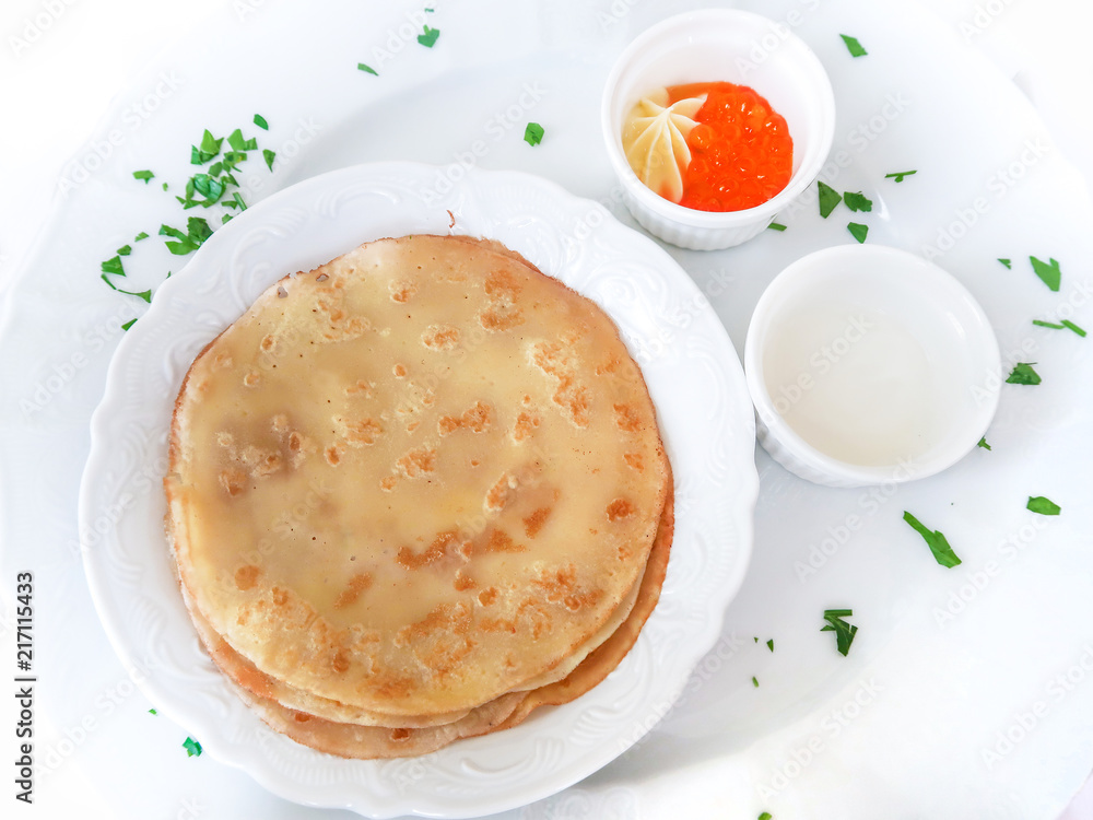 Pancakes with red caviar on white plate Pancakes with red caviar on white plate