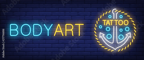 Body art neon text with anchor. Tattoo salon or studio concept. Advertisement design. Night bright neon sign, colorful billboard, light banner. Vector illustration in neon style.
