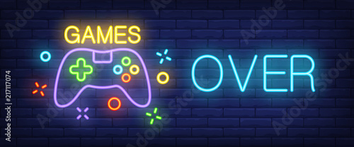 Games, over neon text with controller. Technology and entertainment concept. ...