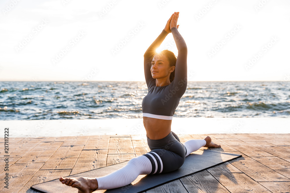 Strong young fitness woman stretching exercises. Strong young fitness woman stretching exercises.