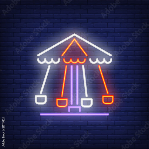 Rotating carousel neon sign. Colorful amusement ride on dark brick wall. Night bright advertisement. Vector illustration in neon style for leisure and childhood
