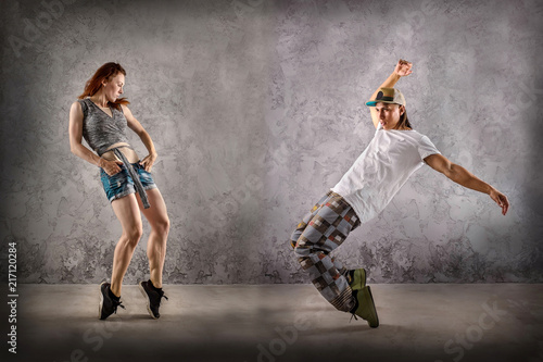Hip Hop dancer in dynamic action jump on the grunge grey 