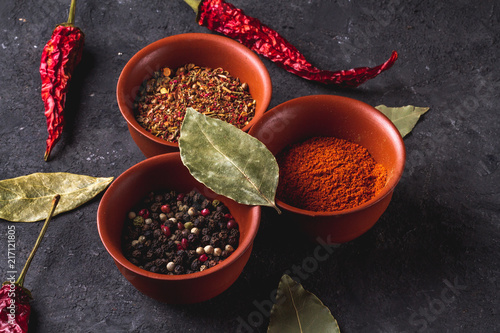 Fototapeta Naklejka Na Ścianę i Meble -  Spicy, tasty, spices and red, dried pepper on a dark background