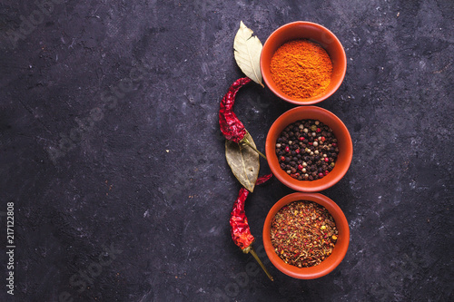 Spicy, tasty, spices and red, dried pepper on a dark background. Copy space