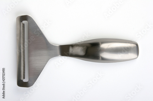 Stinless steel cheese slicer on light background