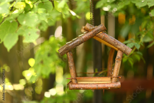 bird wooden creative feeder as a part of garden design element photo