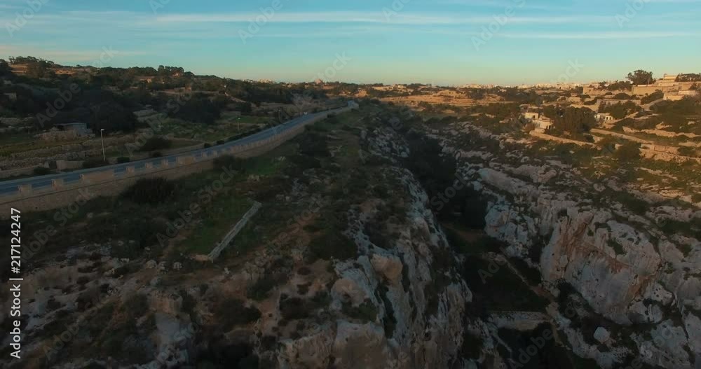 Aerial shot - Flying nearby European Maltese Cliffs during Sunset Aerial shot - Flying nearby European Maltese Cliffs during Sunset
