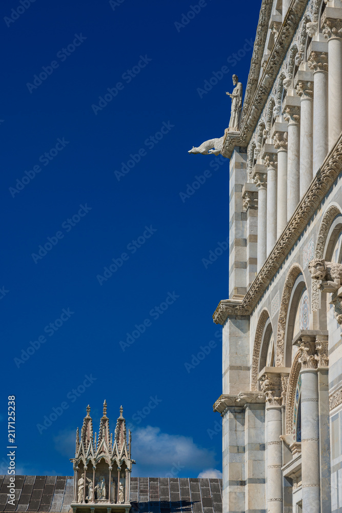 Pisa Cathedral romanesque facade, completed in the 12th century, with blue sky and copy space
