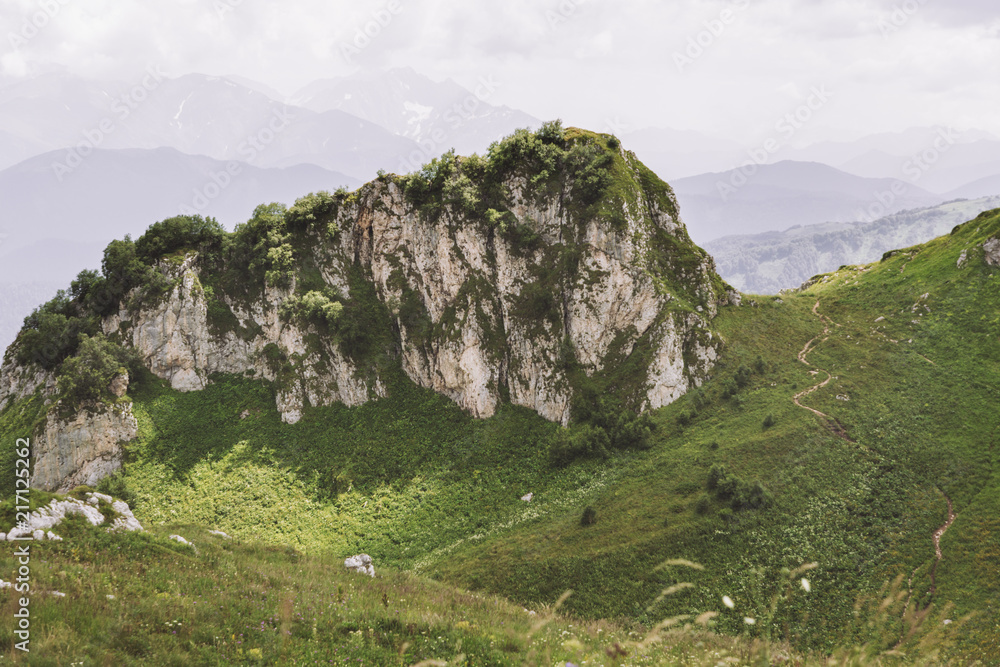 Republic of Adygea / Russia - July 28, 2018: The road through the pass overlooking the rock in the Caucasian Reserve Republic of Adygea / Russia - July 28, 2018: The road through the pass overlooking the rock in the Caucasian Reserve