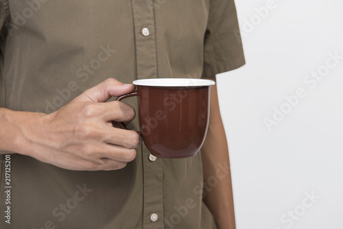Hand Holding brown coffee cup. mockup for creative design branding.