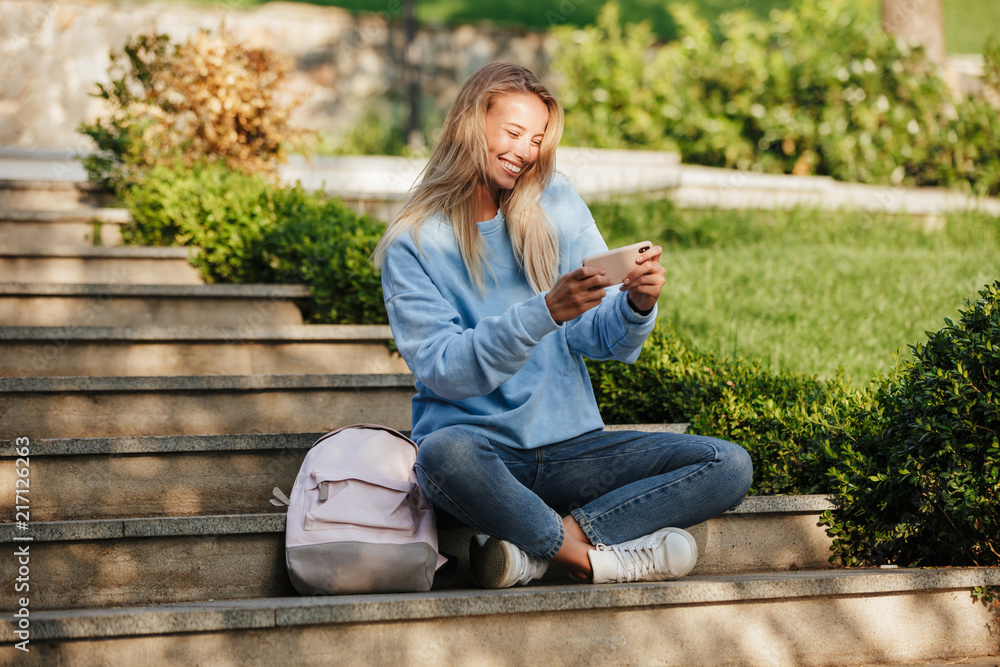 Portrait of a cheerful young girl student with backpack Portrait of a cheerful young girl student with backpack