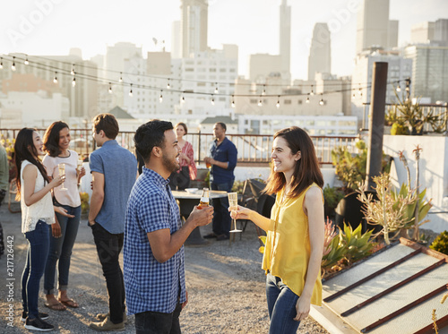 Friends Gathered On Rooftop Terrace For Party With City Skyline In Background © Monkey Business