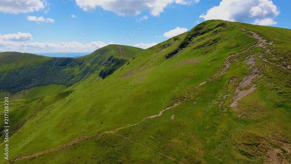 Aerial shot of a spiky range with ground lane in the Carpathians in summer Aerial shot of a spiky range with ground lane in the Carpathians in summer