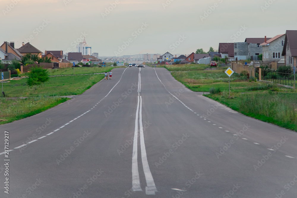 Fototapeta premium Sidewalk and street.New English Property.Asphalt road in a beautiful modern area. A wide road near the house. Way home. Highway to the city