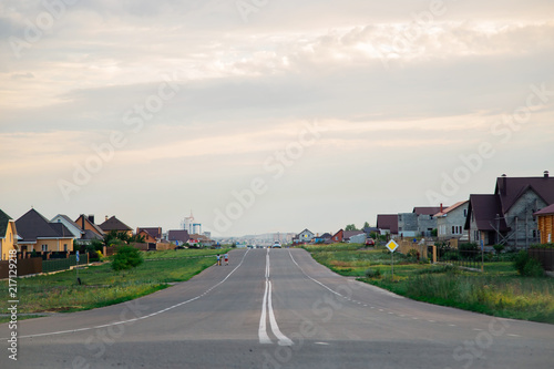 Sidewalk and street.New English Property.Asphalt road in a beautiful modern area. A wide road near the house. Way home. Highway to the city