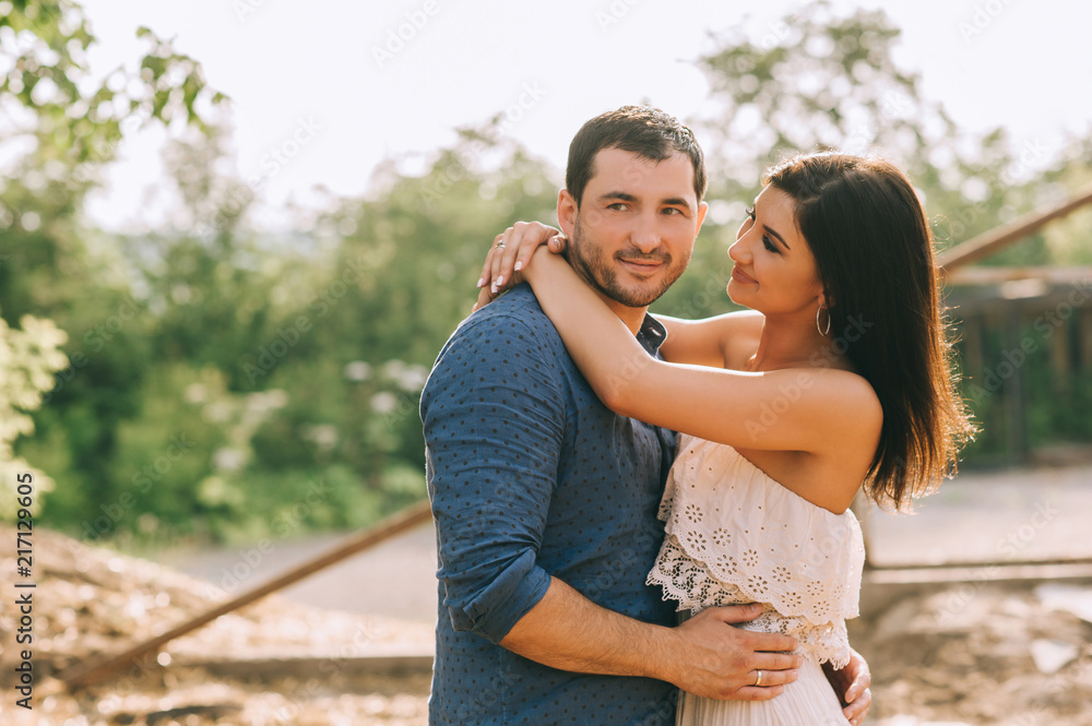 Fototapeta premium cheerful husband and wife hugging outdoors