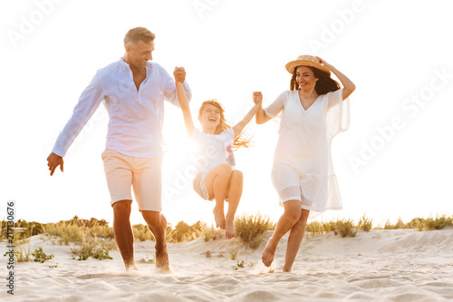 Cute family having fun together outdoors at the beach.