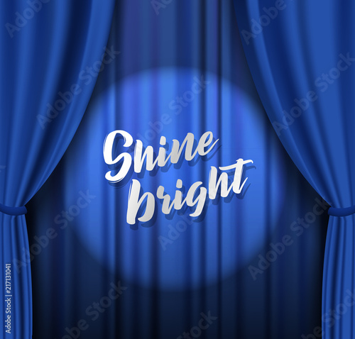 Teather stage with blue heavy curtain with golden text and stars.