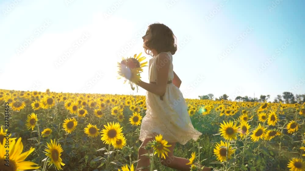 Happy little girl running happy free across the field with lifestyle sunflowers. slow motion video . smelling big sunflower on summer field. Delight of a pleasant smell. Summer holiday. concept Happy little girl running happy free across the field with lifestyle sunflowers. slow motion video . smelling big sunflower on summer field. Delight of a pleasant smell. Summer holiday. concept