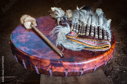 Feather headdress, ancient amerindian leather tambourine and drum drumstick. Attributes of the ancient american indian.