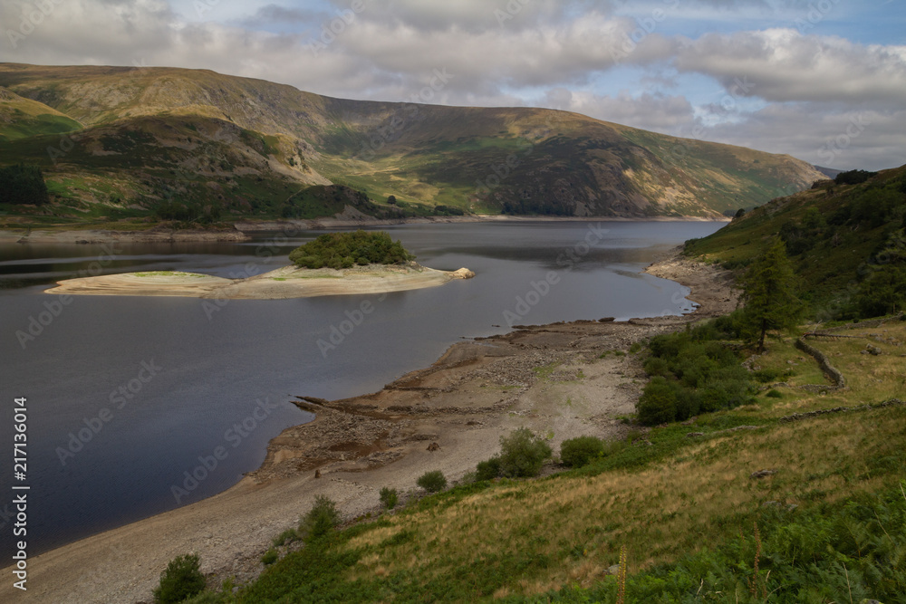 Obraz premium Low Water level at Haweswater reservoir reveals the remains of the village of Mardlae Green in summer 2018