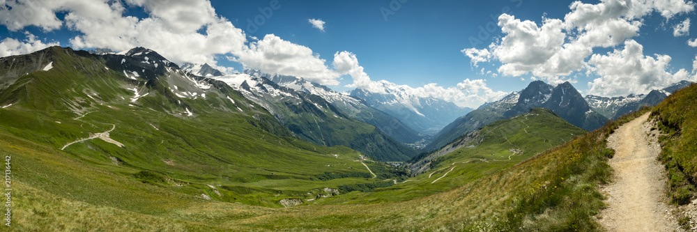 Fototapeta premium view of mont blanc and the valley surrounding chamonix in the french alps during summer showing green alpine meadows, pristine mountains and clear blue skies