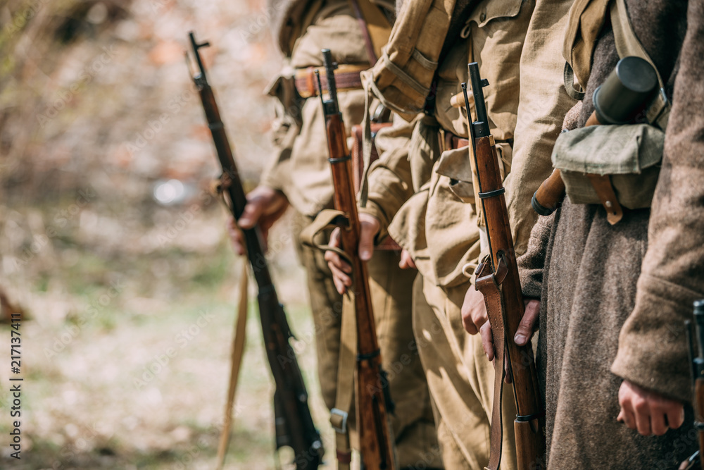 Close Up Of Re-enactors Dressed As Soviet Infantry Soldiers Of World War II Holds Rifles Weapons In Hands.