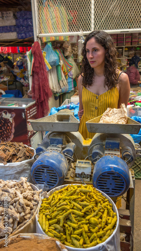 Tourist woman shopping moruna spices in a market of Morocco village.  photo