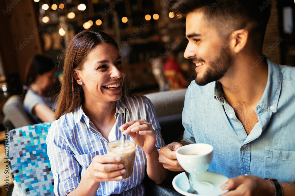 Young attractive couple on date in coffee shop Young attractive couple on date in coffee shop