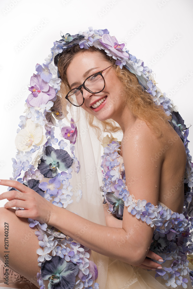 Pretty girl with glasses and with orchids on head on white background. Fashion Beauty Concept Pretty girl with glasses and with orchids on head on white background. Fashion Beauty Concept