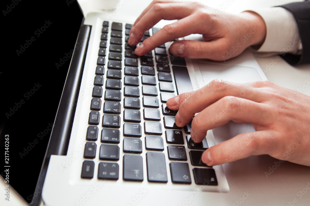 Man hand on laptop keyboard