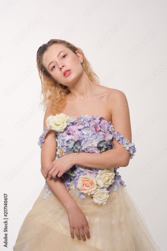 Studio portrait of blooming gorgeous lady in dress of flowers. Fashion concept Studio portrait of blooming gorgeous lady in dress of flowers. Fashion concept