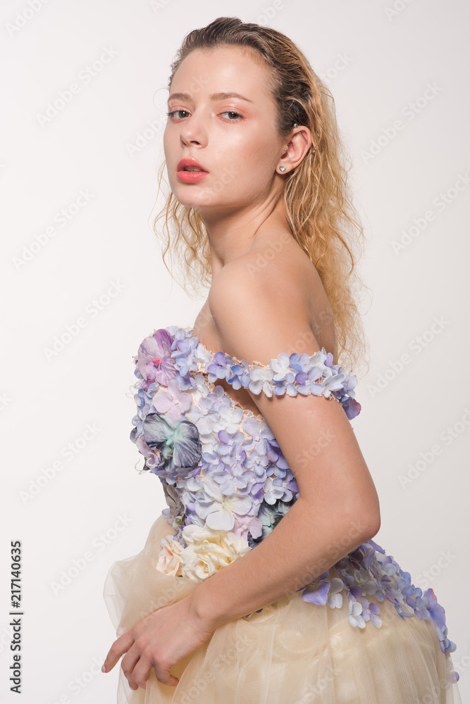 Studio portrait of blooming gorgeous lady in dress of flowers. Fashion concept Studio portrait of blooming gorgeous lady in dress of flowers. Fashion concept