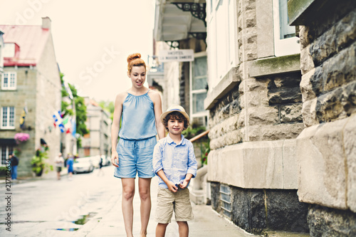 Mother with her son outside in an urban street © Louis-Photo