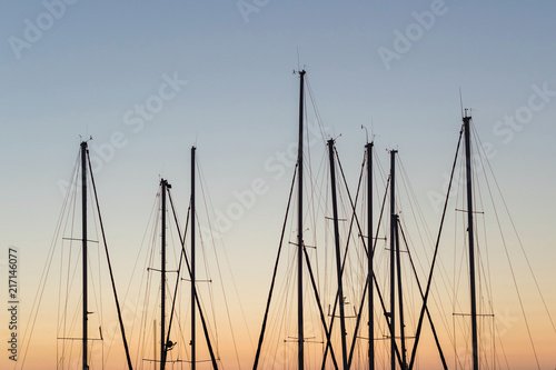 Close Up of yacht masts on the sunset sky background