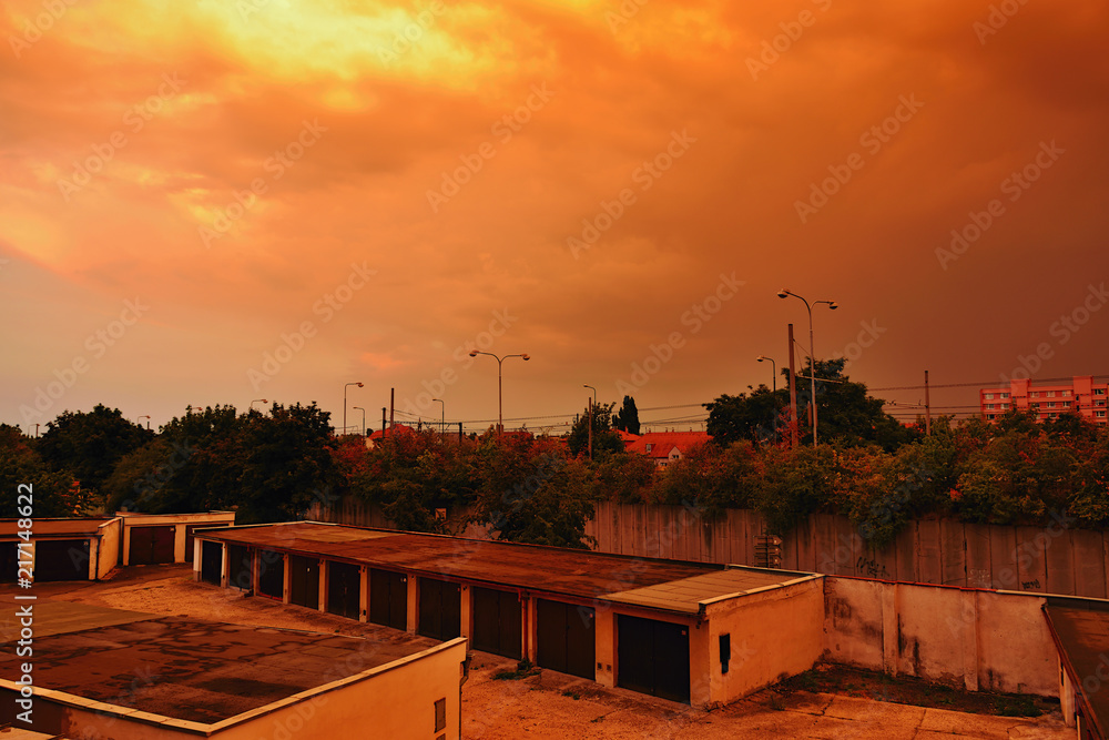 Chomutov, Czech republic - July 15, 2018: colorful sky during sunset after storm with garages in foreground in summer evening