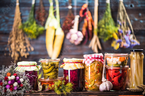 фотографія Pickled Marinated Fermented vegetables on shelves