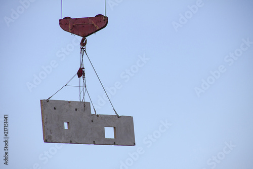 Hoisting construction works with tower crane photo