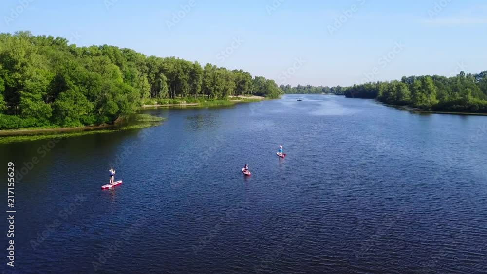 Three young people are kayaking on the river Three young people are kayaking on the river