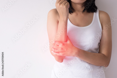 Woman with pain in the arm,Female hand touching her painful arms