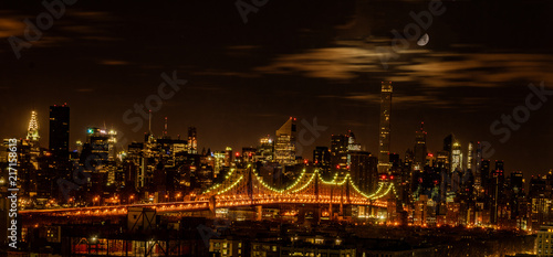 Queensboro Bridge seen at night with the moon overhead photo